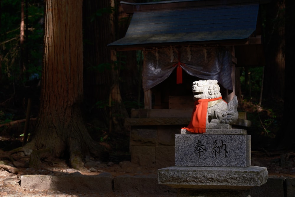 a statue of a white dog with a red scarf around it's neck