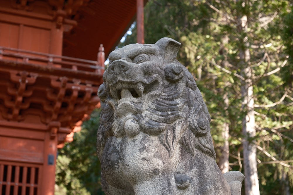 a stone lion statue in front of a building