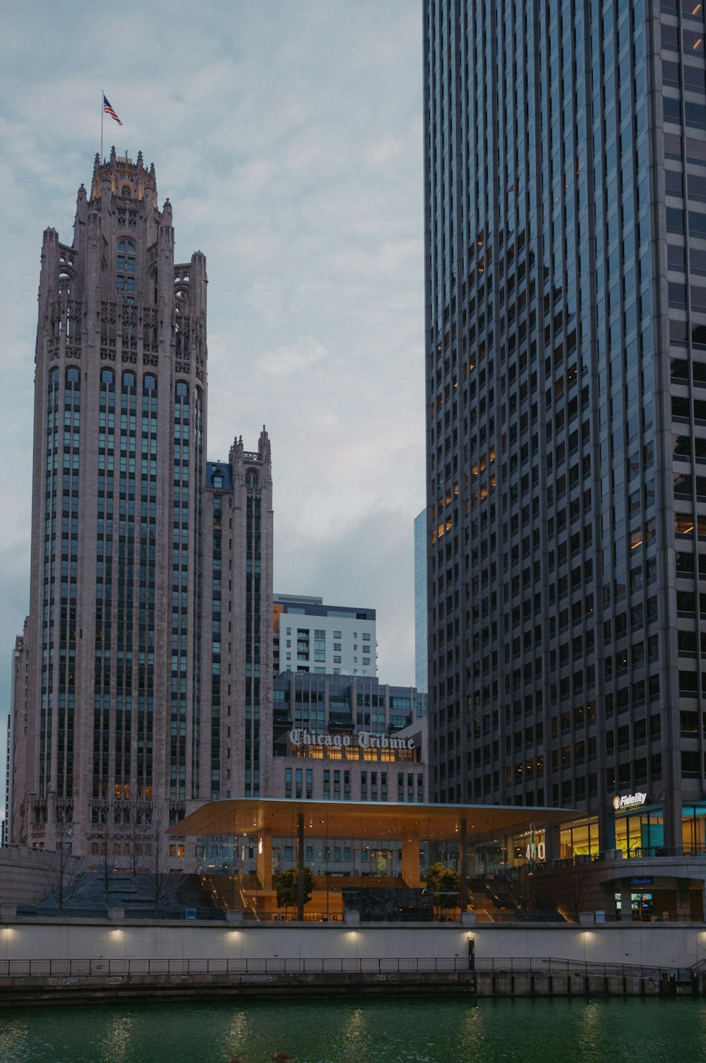 a body of water in front of tall buildings