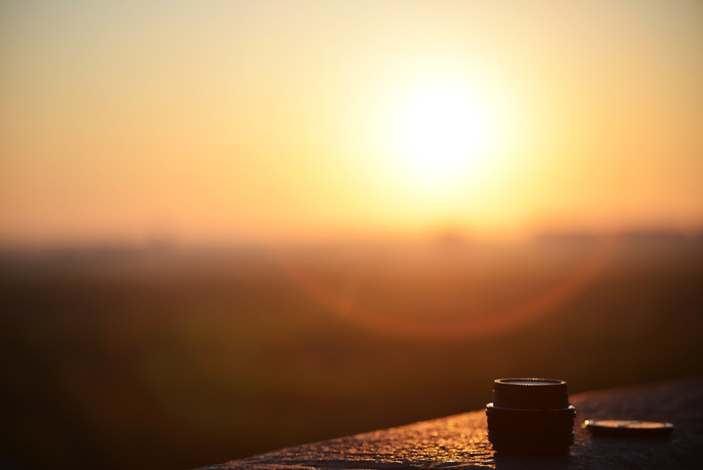 a cup of coffee sitting on top of a wooden table