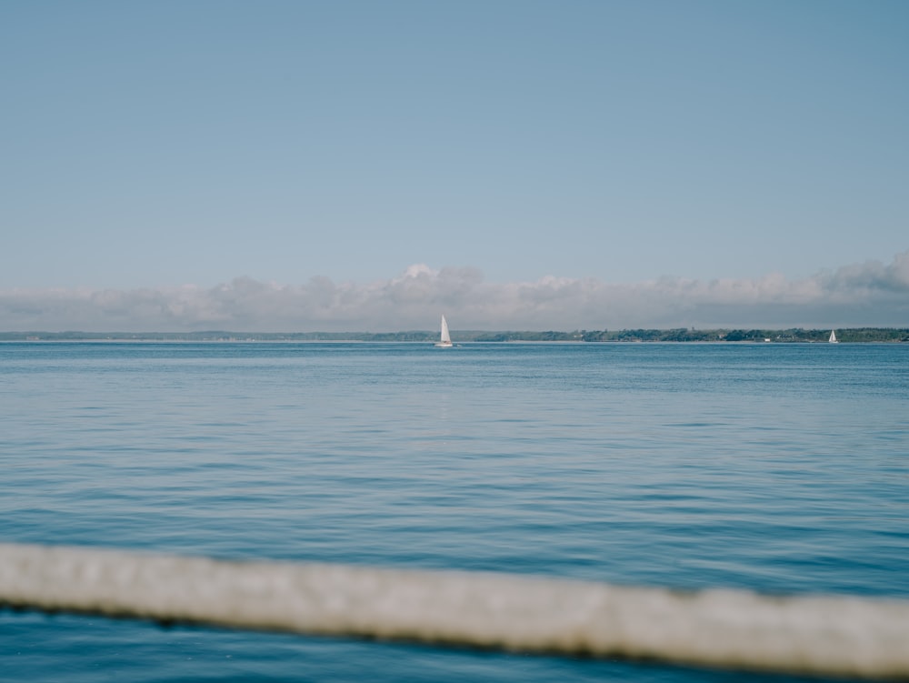 a sailboat sailing across a large body of water