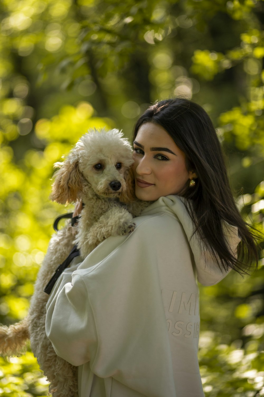 a woman holding a dog in her arms