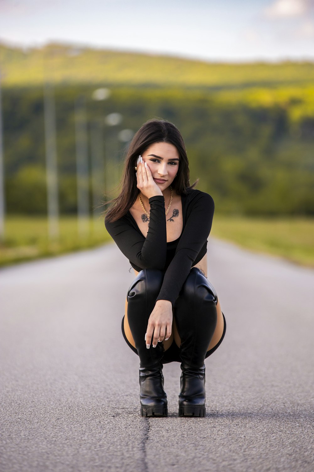 a woman sitting on the side of a road