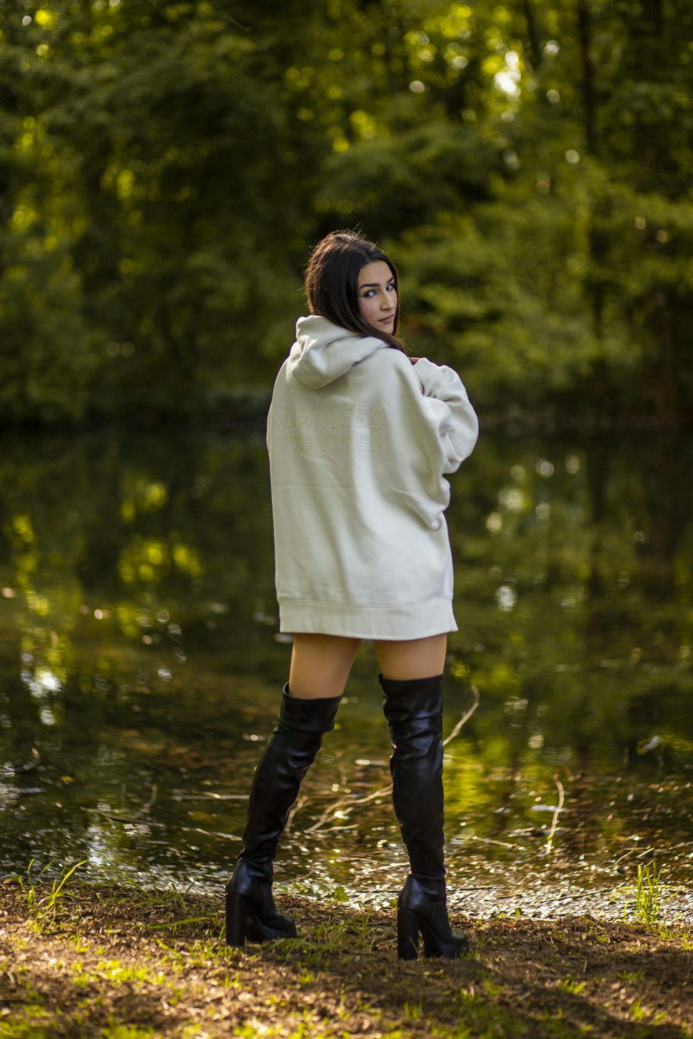 a woman in a white jacket and black boots