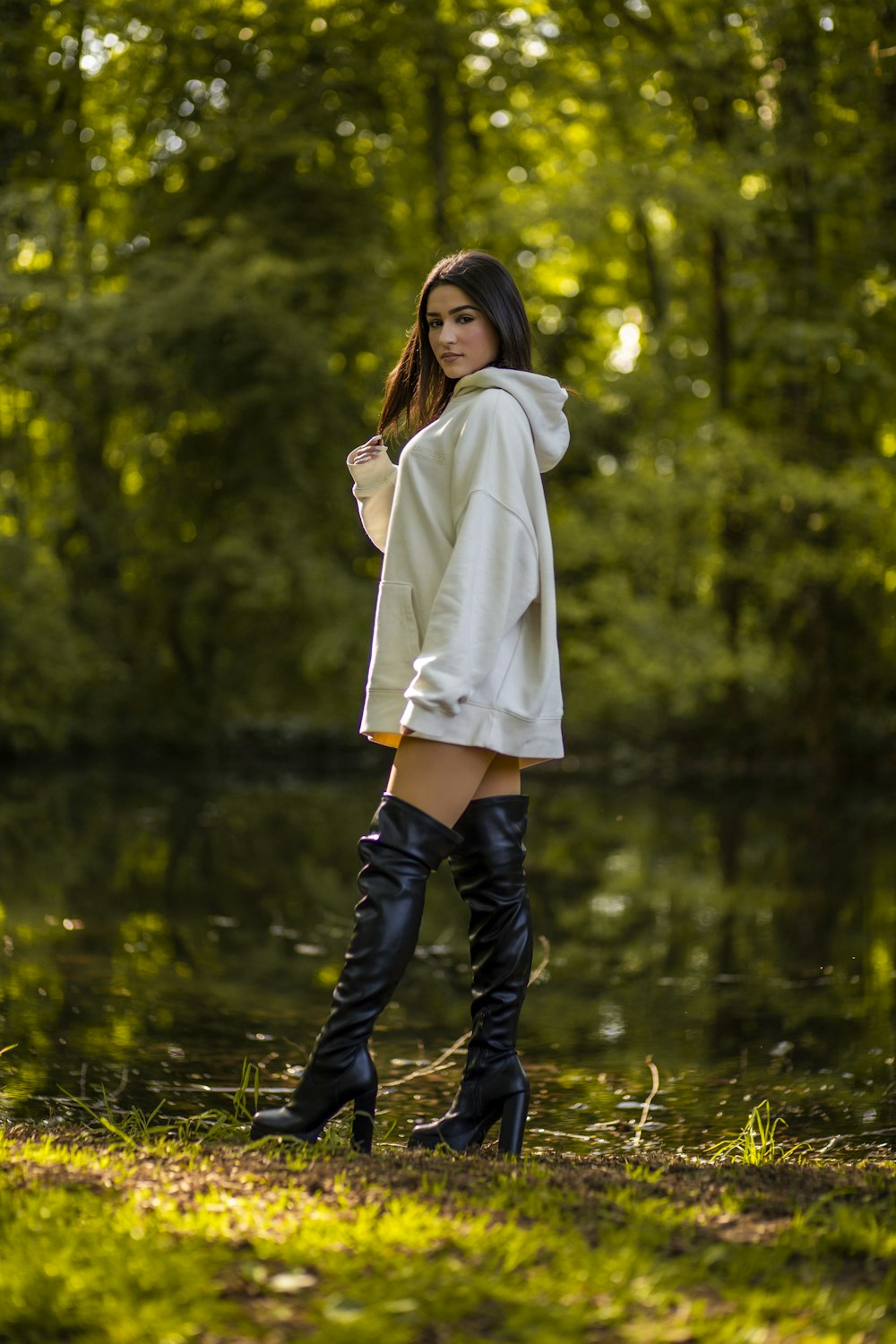 a woman in a white sweater and black boots