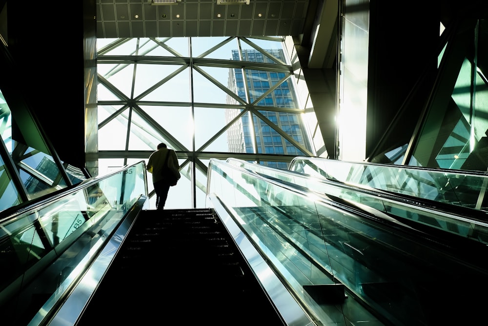 a man standing on an escalator in a building