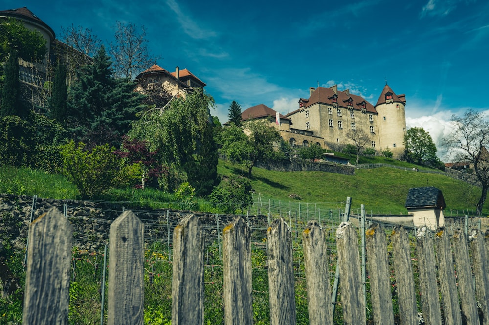 a castle on top of a hill with a fence in front of it