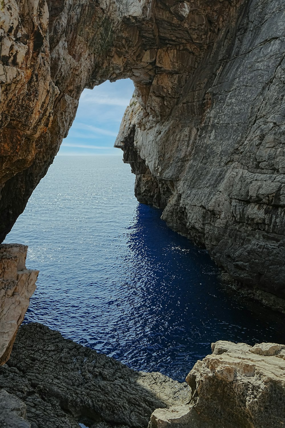 a view of a body of water from a rocky cliff