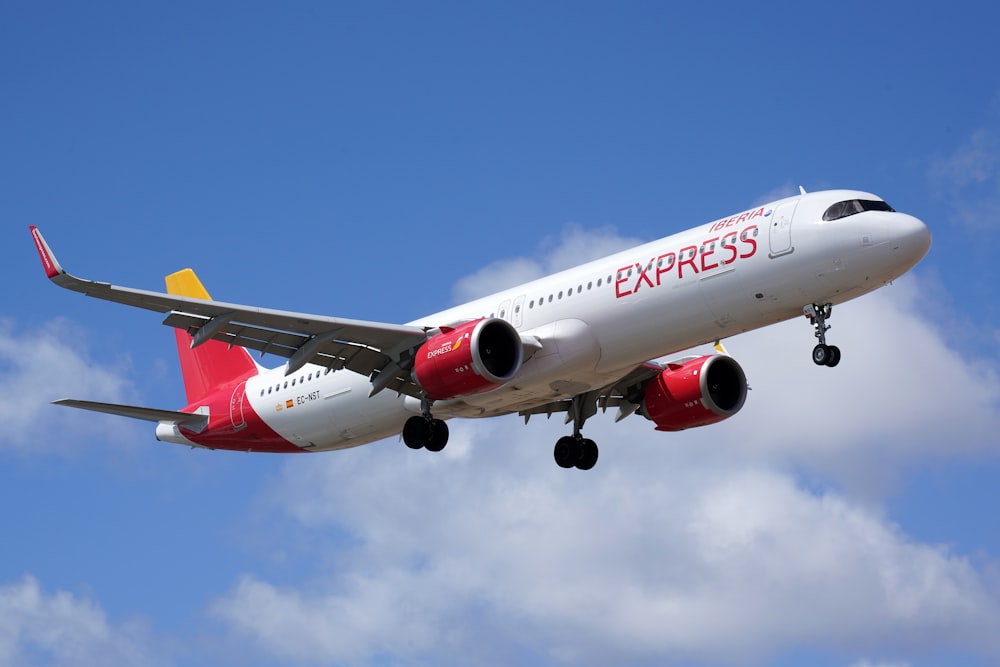 a large passenger jet flying through a cloudy blue sky