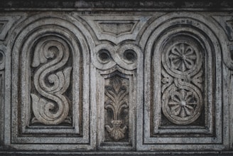 a close up of a stone wall with carvings on it