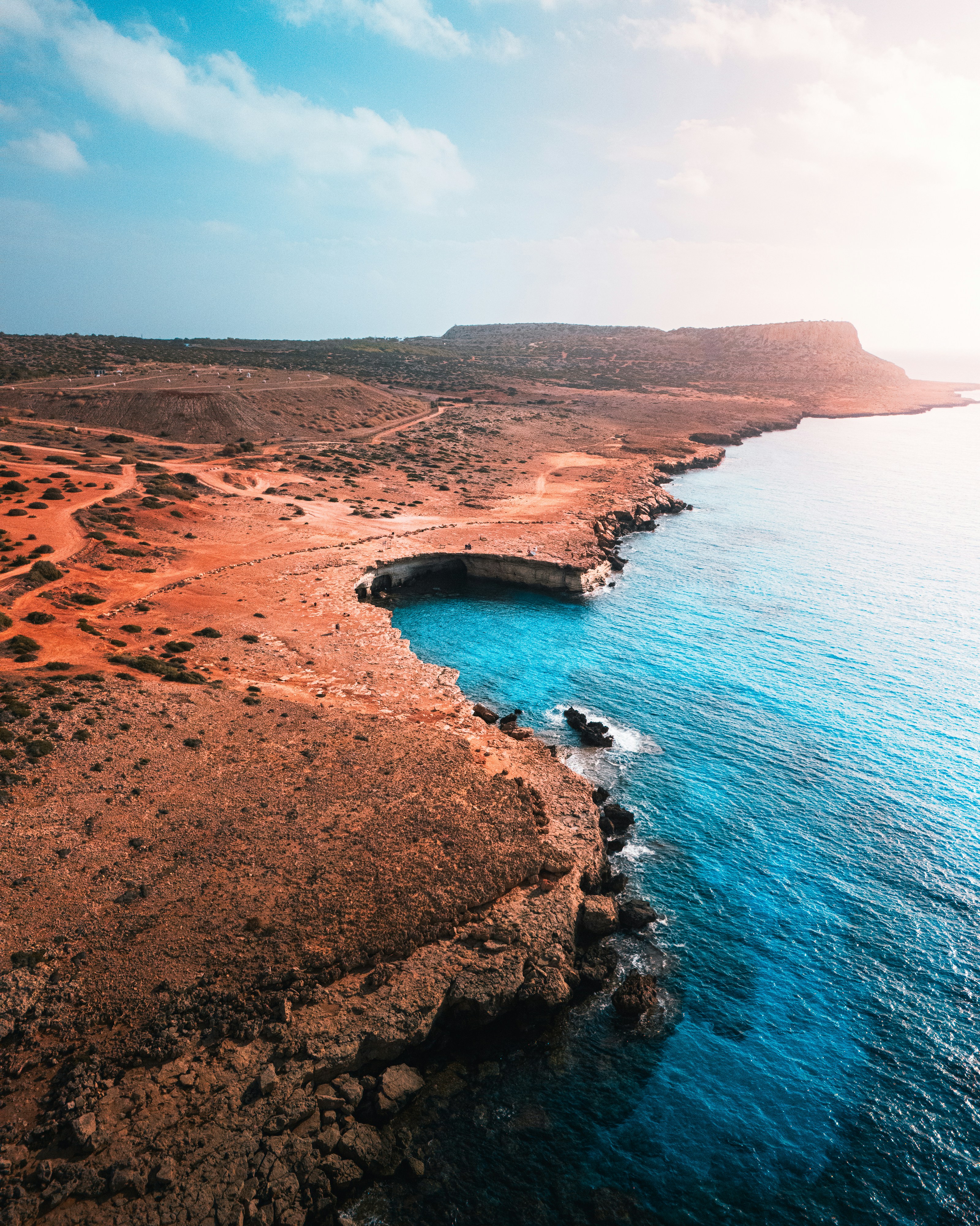 a large body of water next to a rocky shore