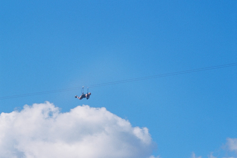 two airplanes flying in the sky on a cloudy day