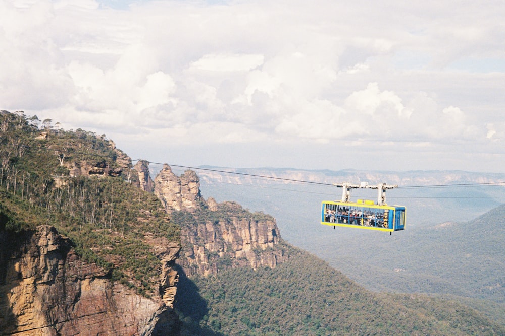 a cable car is suspended over a mountain range