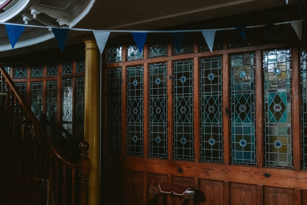 a room with a wooden wall and stained glass windows
