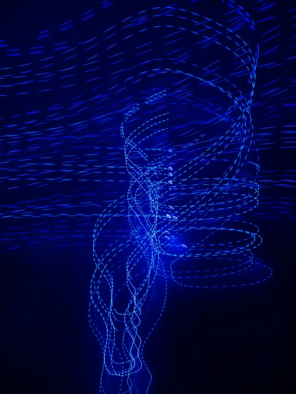 a spiral of blue lights in the dark