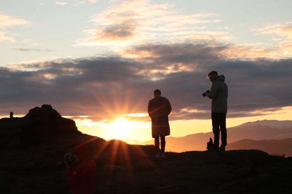 a group of people standing on top of a mountain