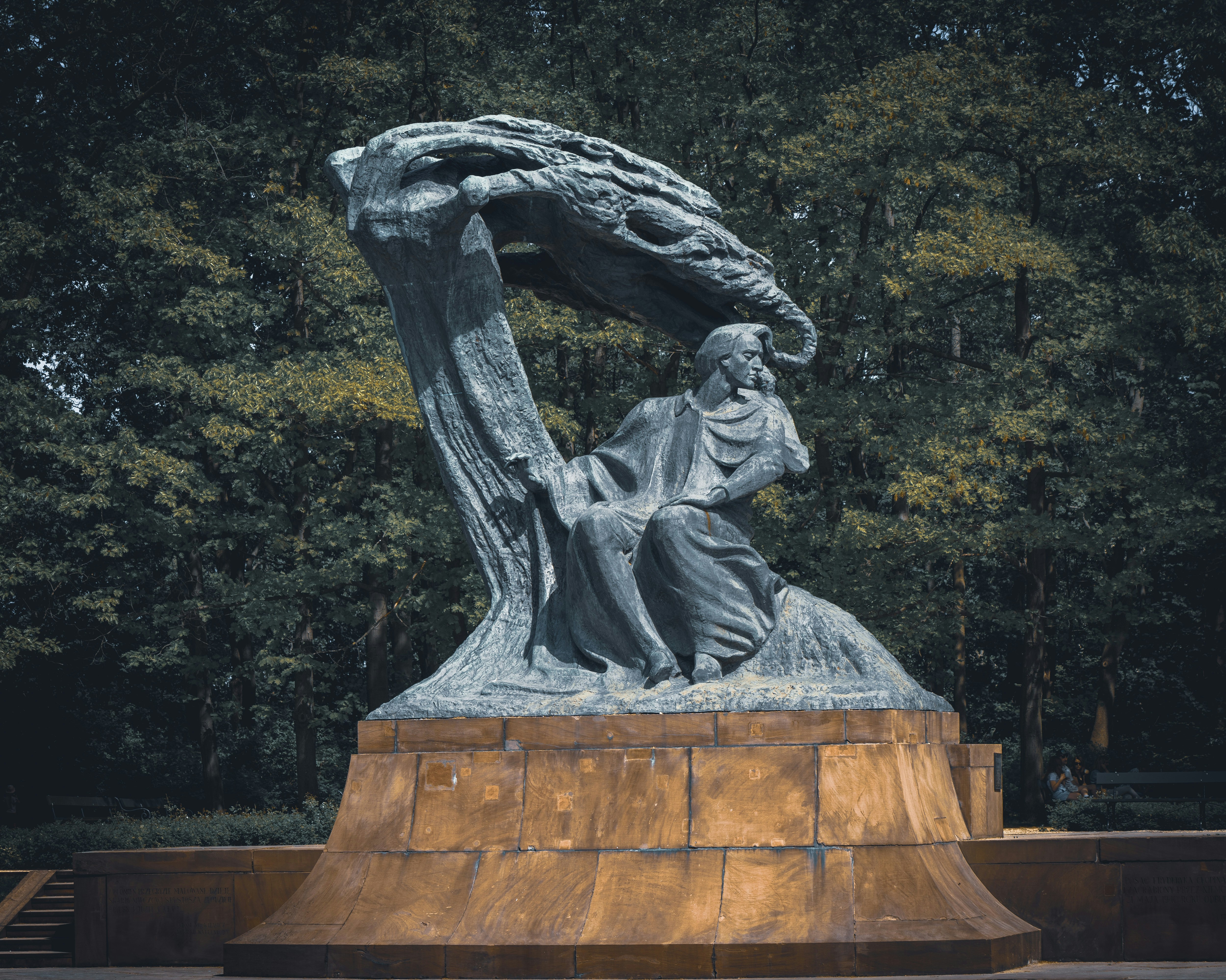 a statue of a woman holding a tree branch