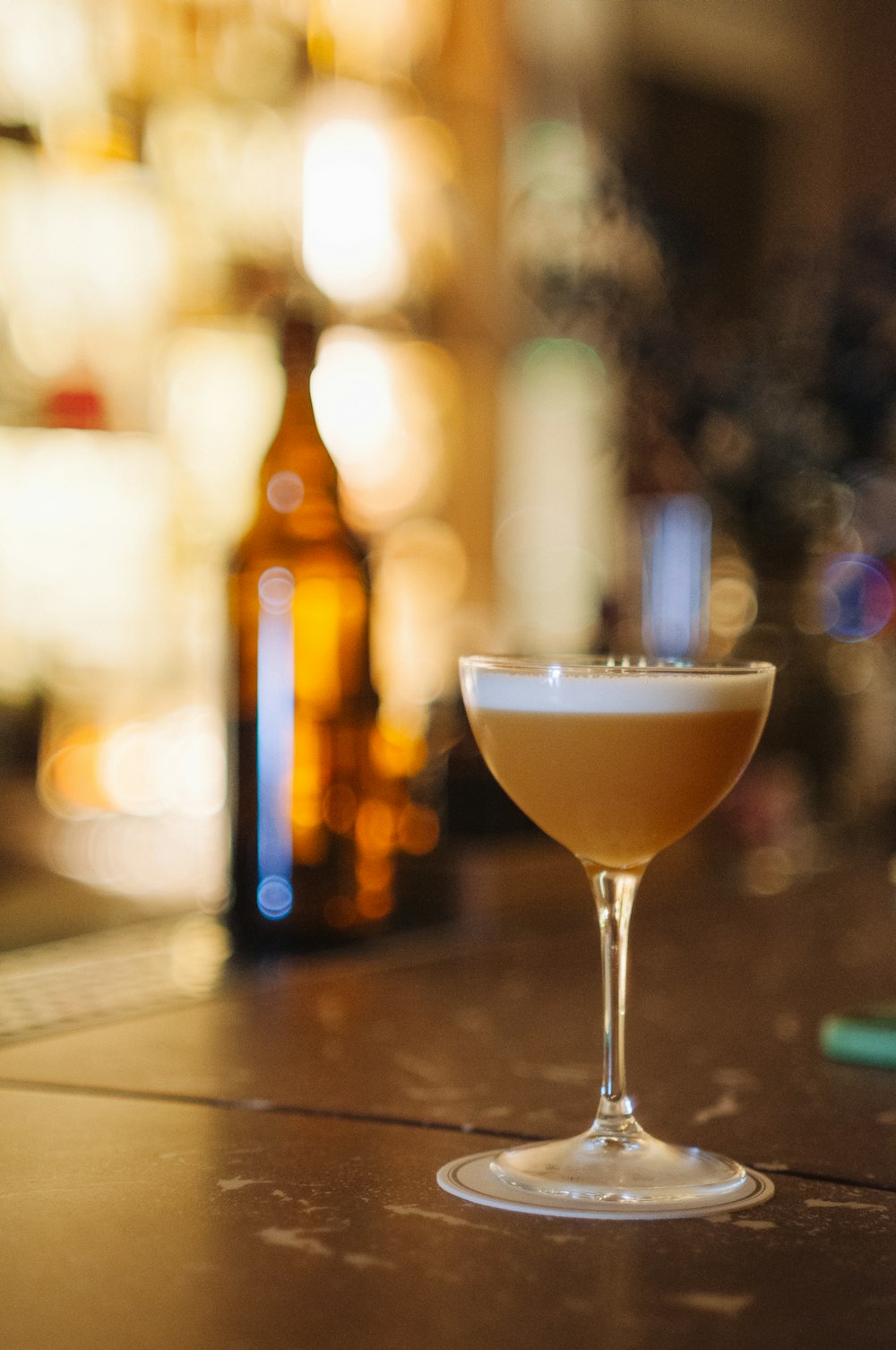 a glass filled with a liquid sitting on top of a table