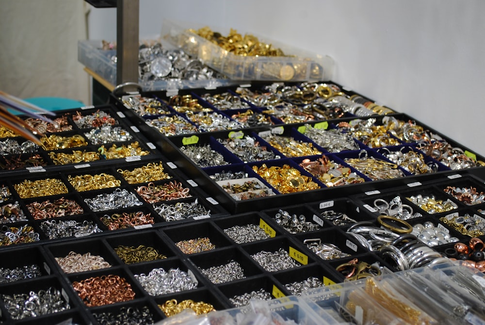 a table filled with lots of different types of jewelry