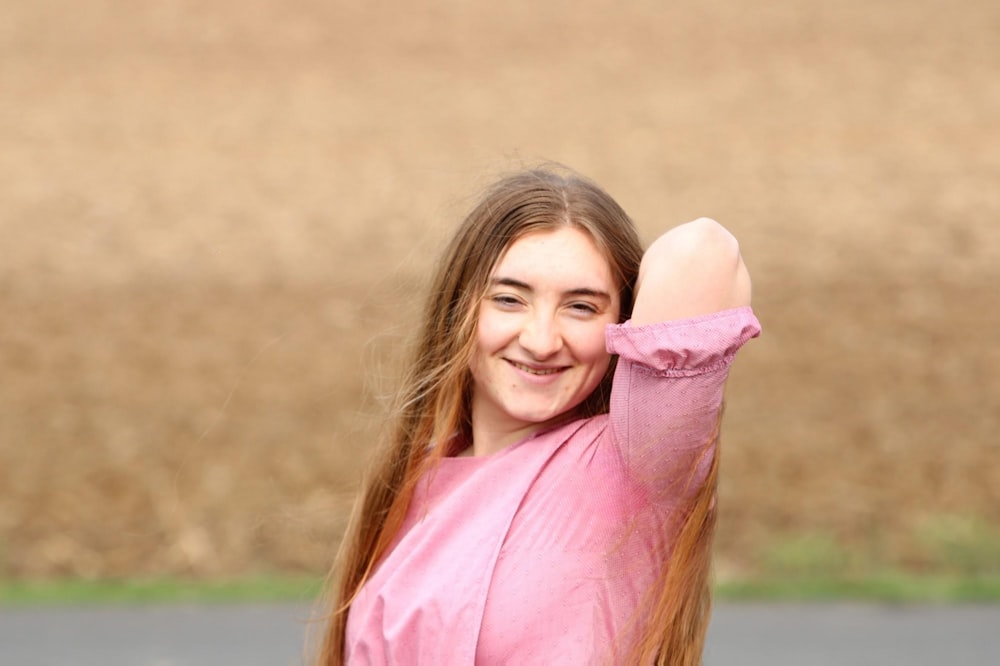 a woman with long hair is posing for a picture