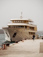 a large white boat docked at a pier