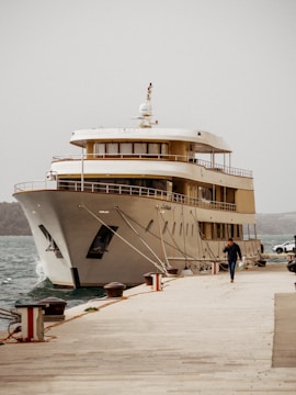 a large white boat docked at a pier