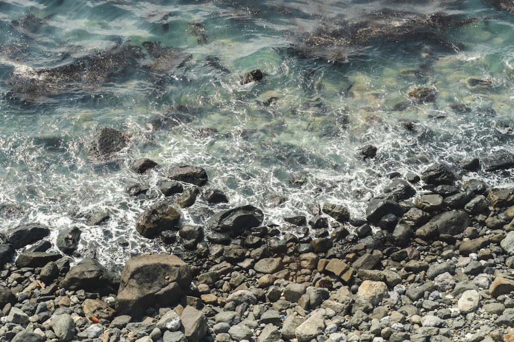 a view of the ocean from above of a rocky beach