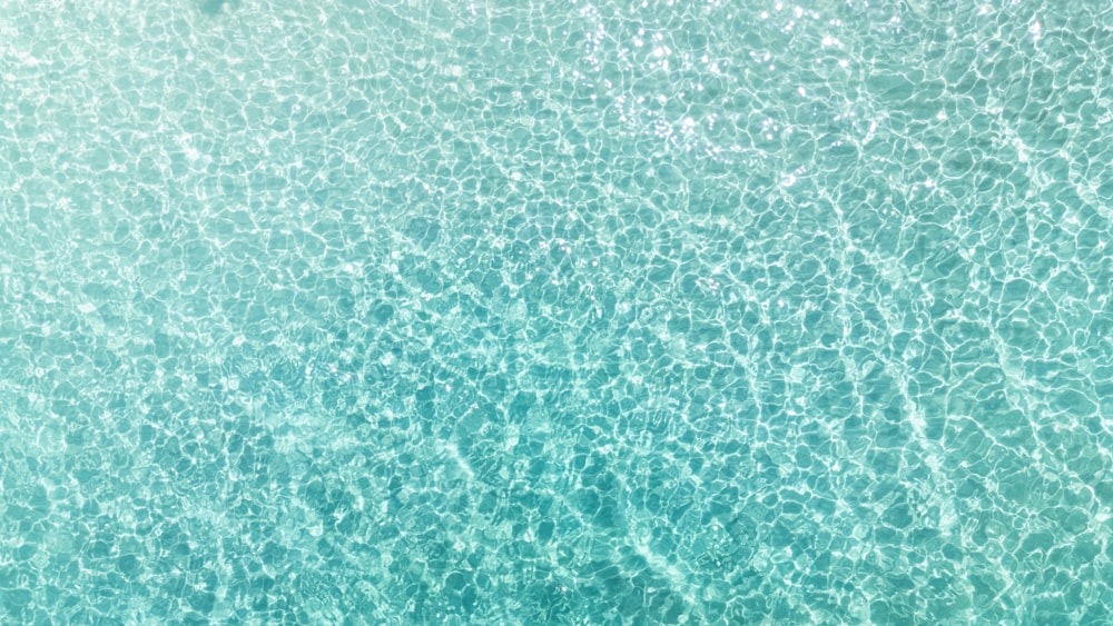 an aerial view of the ocean with a boat in the water