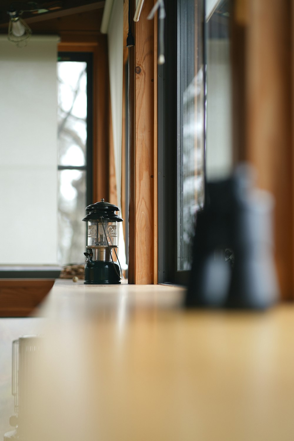 a blender sitting on top of a counter next to a window