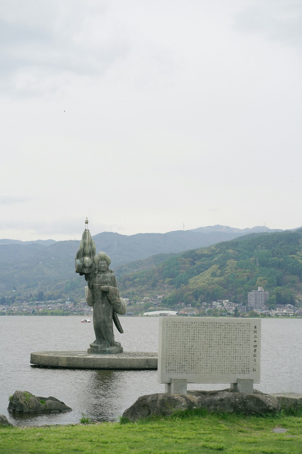 a statue in the middle of a body of water