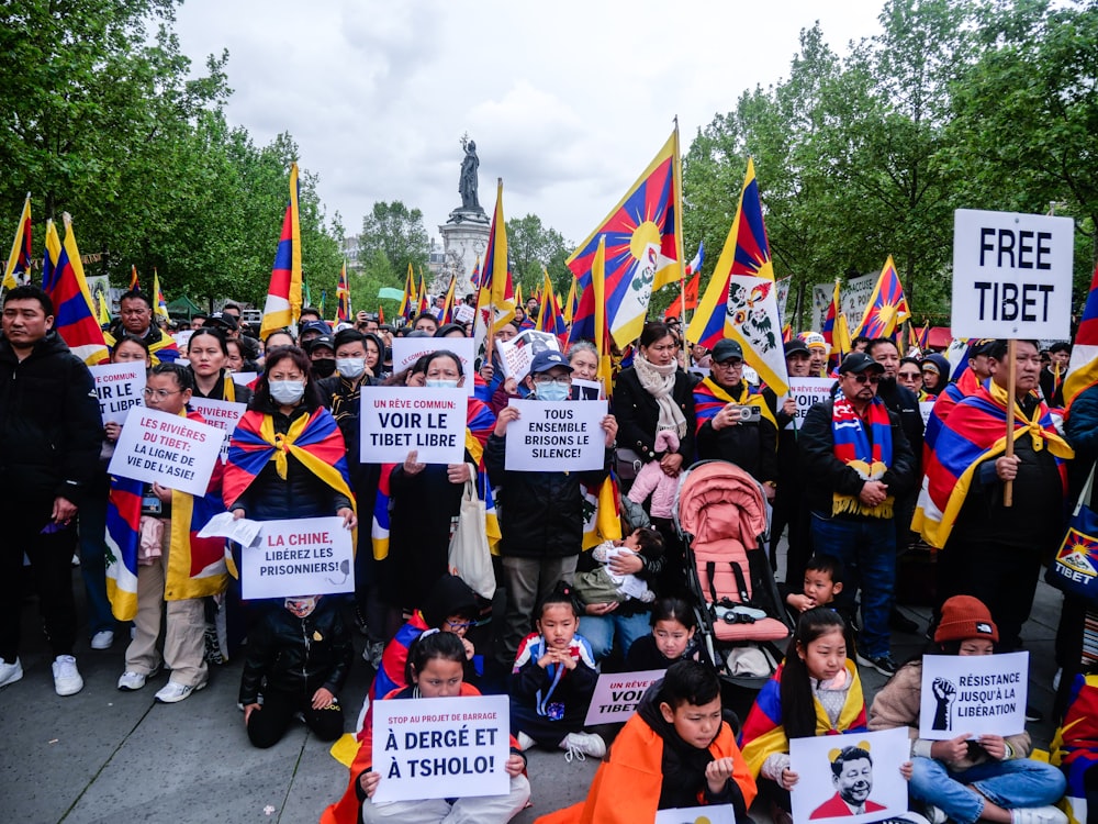 a large group of people holding signs and flags