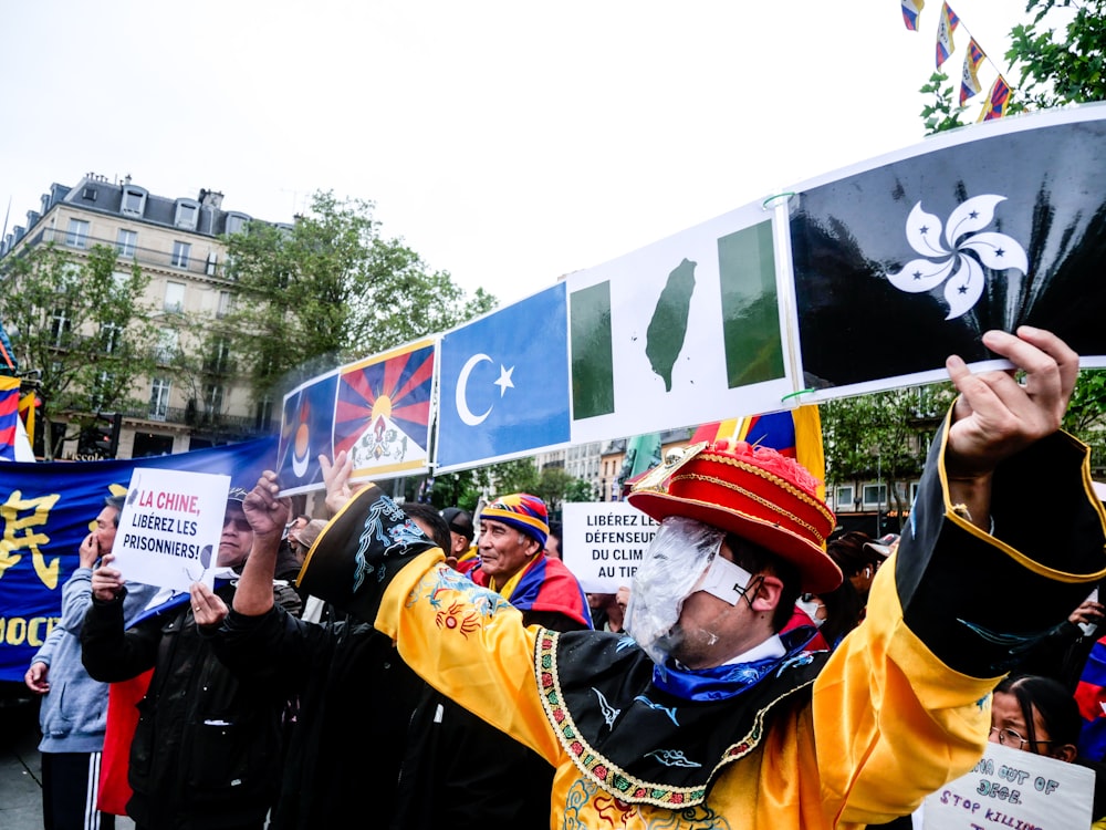 a group of people holding up signs in the air