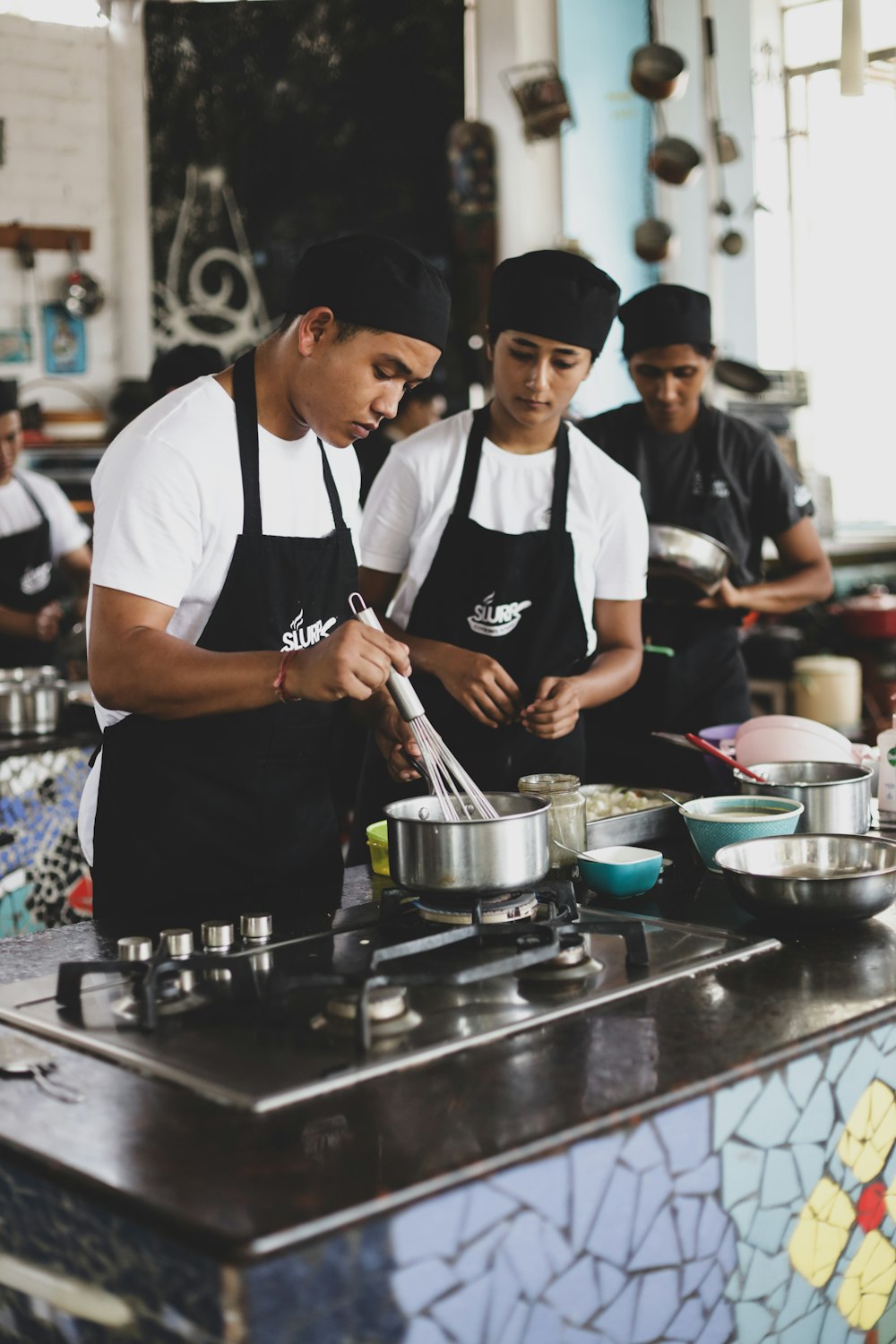 a group of men cooking in a kitchen