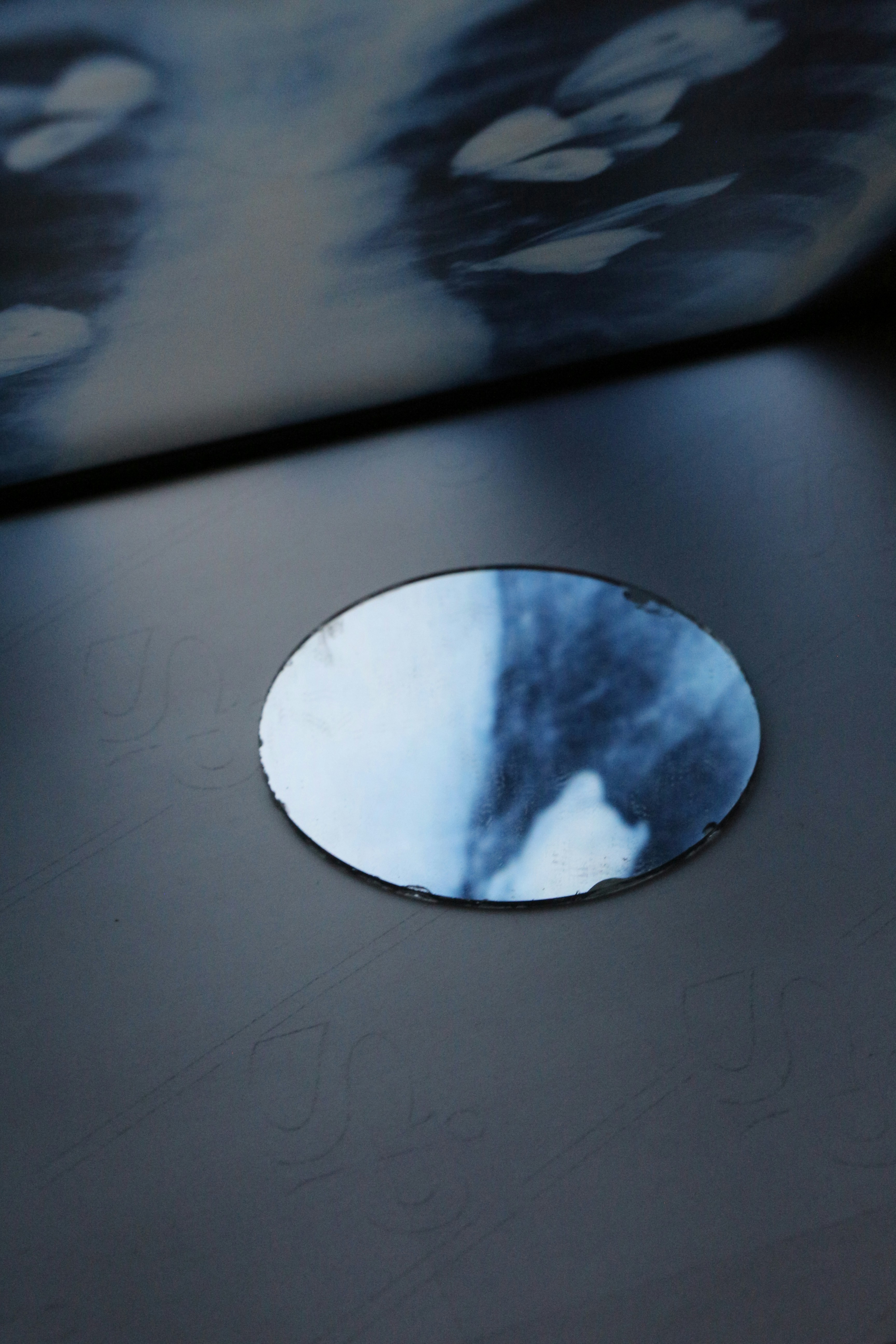 a round mirror sitting on top of a table