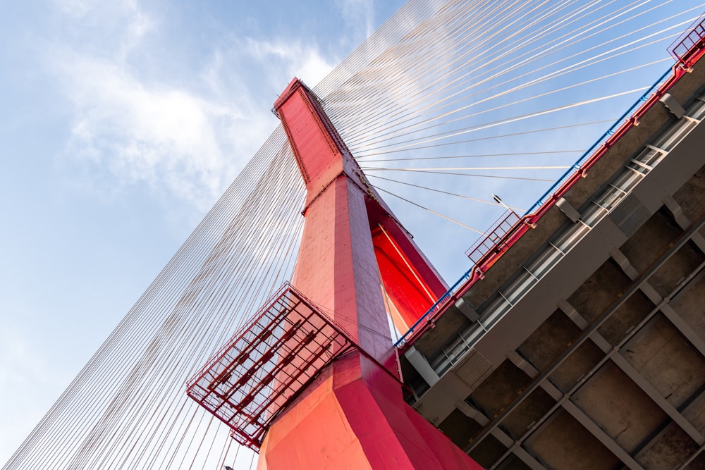 a view of a red and white bridge with a blue sky in the background