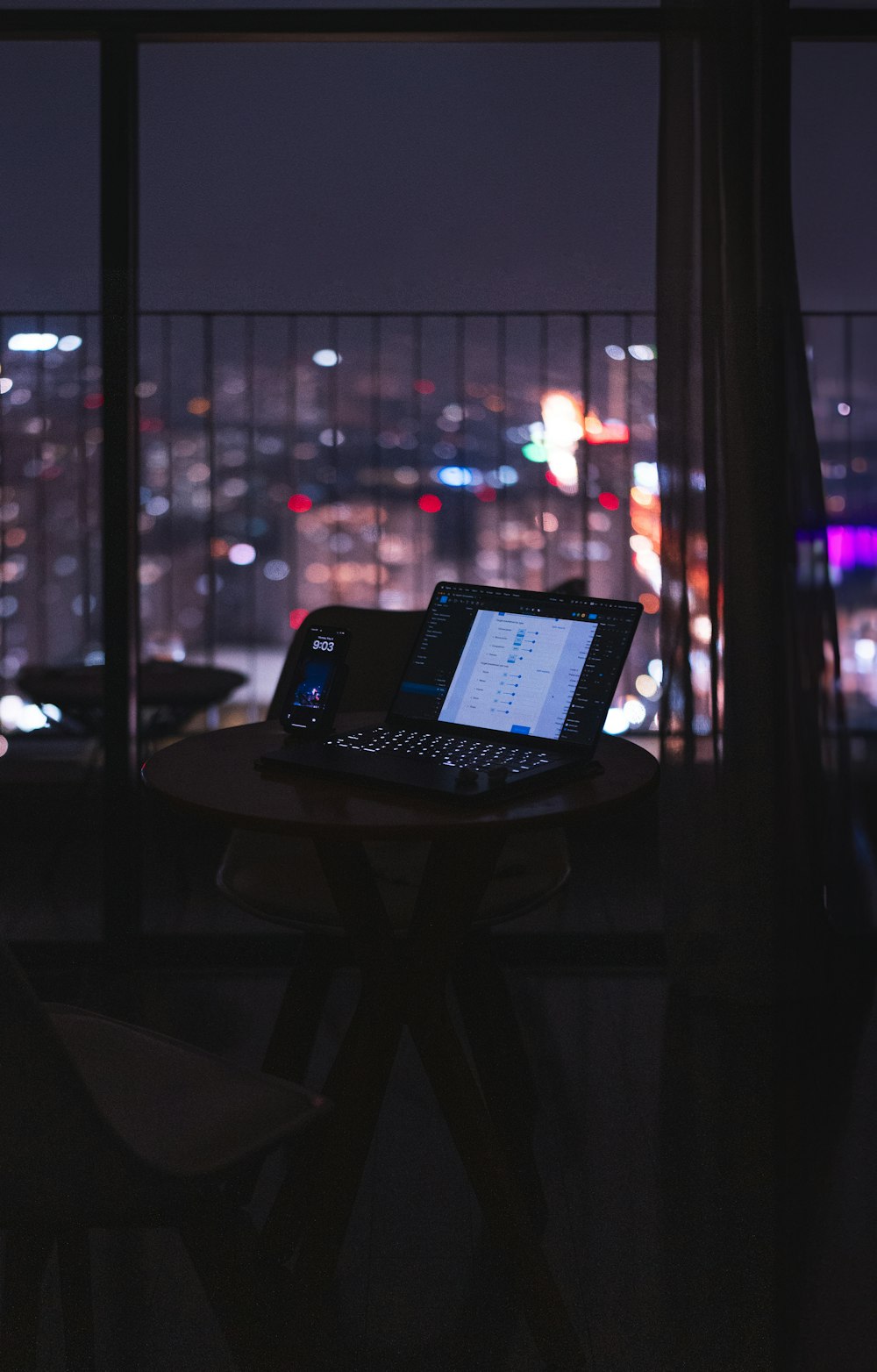 a laptop computer sitting on top of a wooden table