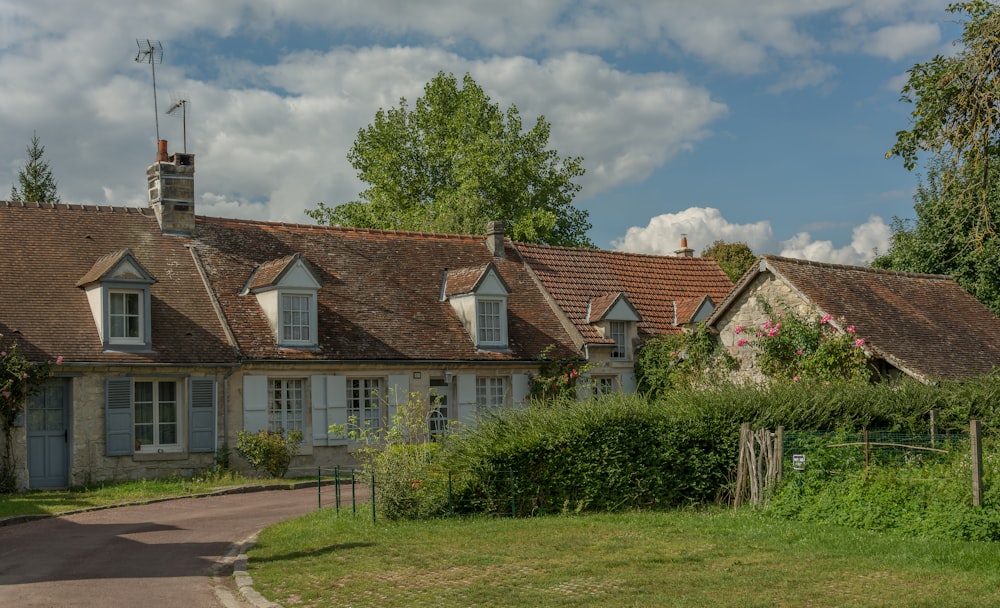 a house with a lot of windows next to a road