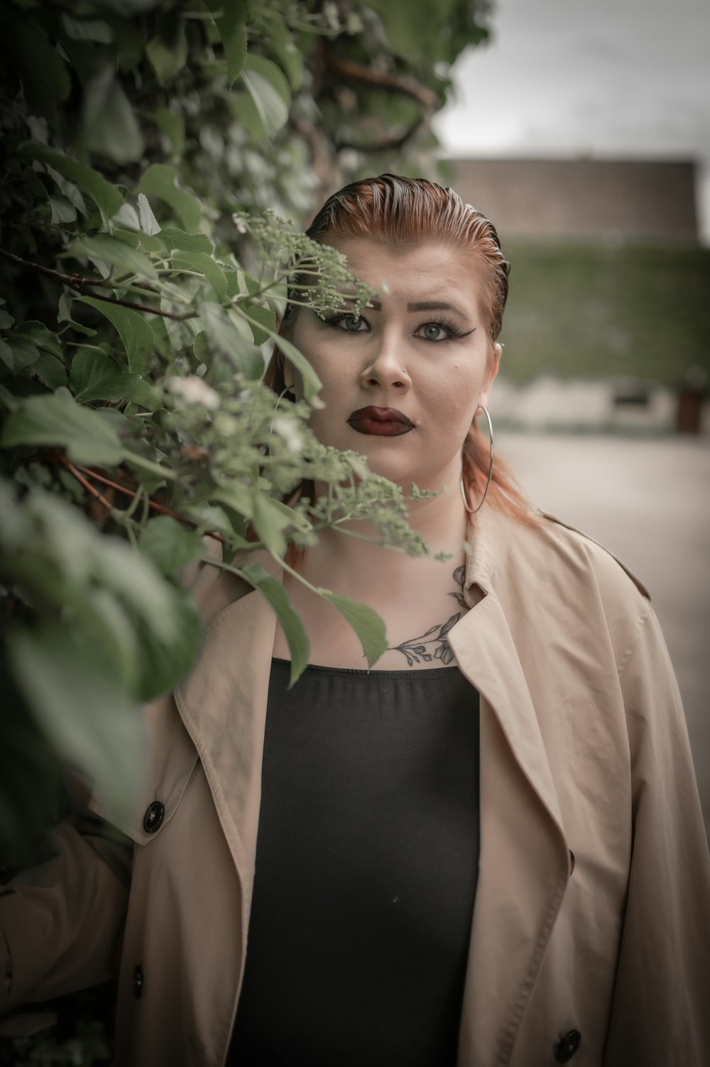 a woman with red hair wearing a trench coat