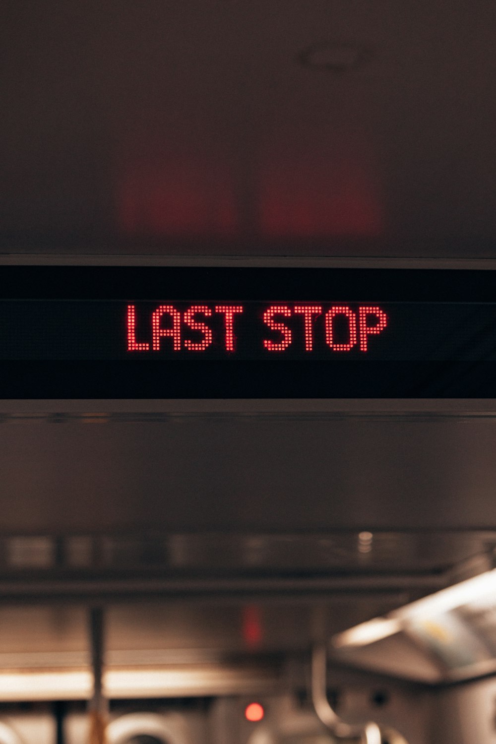 a red sign that says last stop on it