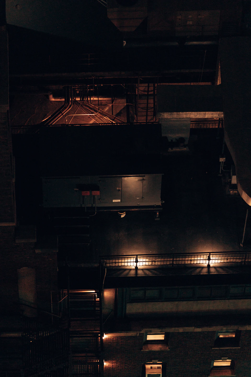 Tall buildings with illuminated windows dominate the night cityscape from a high vantage point