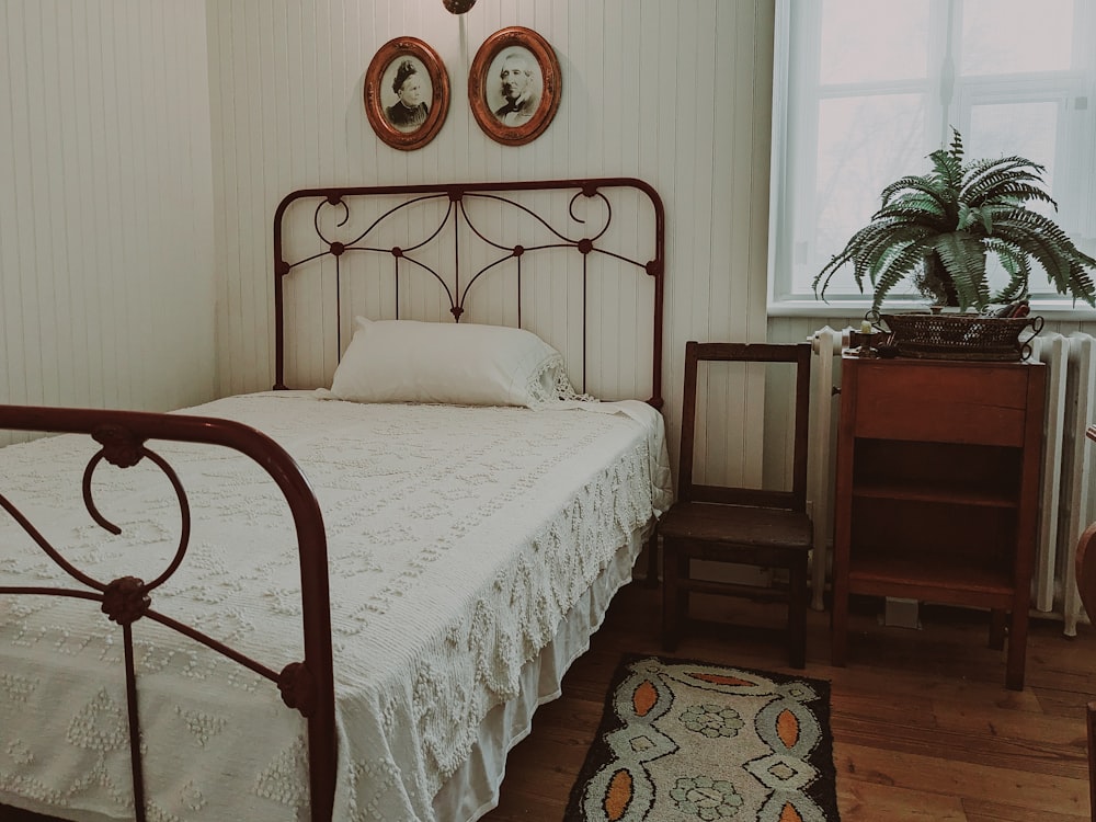 a bed with a white bedspread in a room