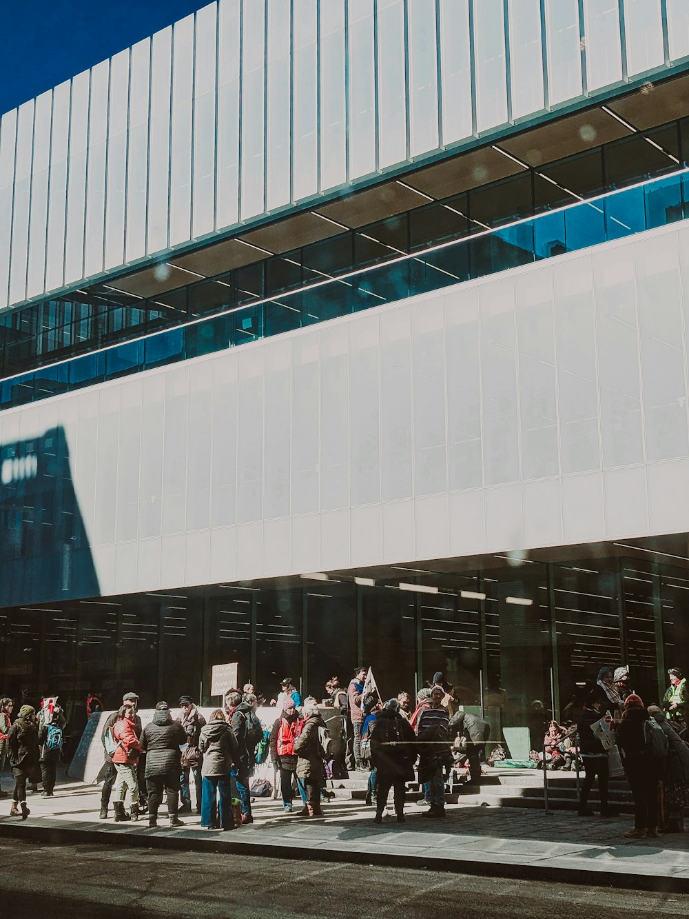 a group of people standing outside of a building