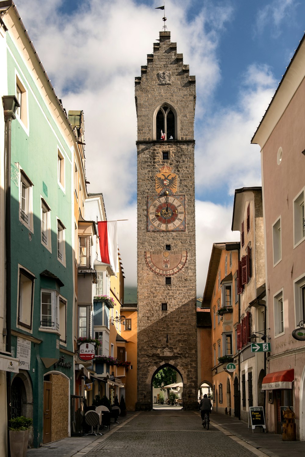 a tall clock tower towering over a city street