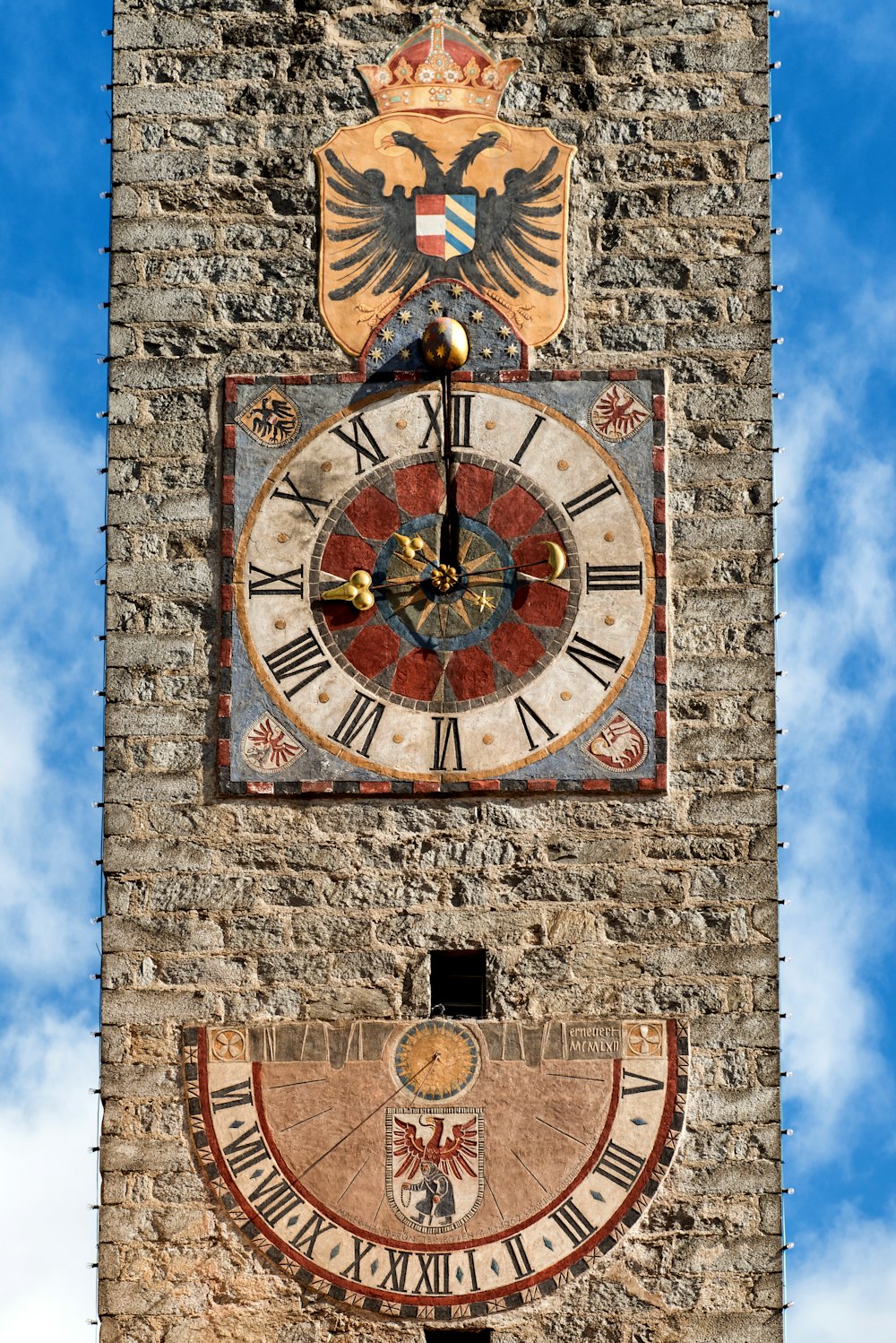 a clock on the side of a building with roman numerals