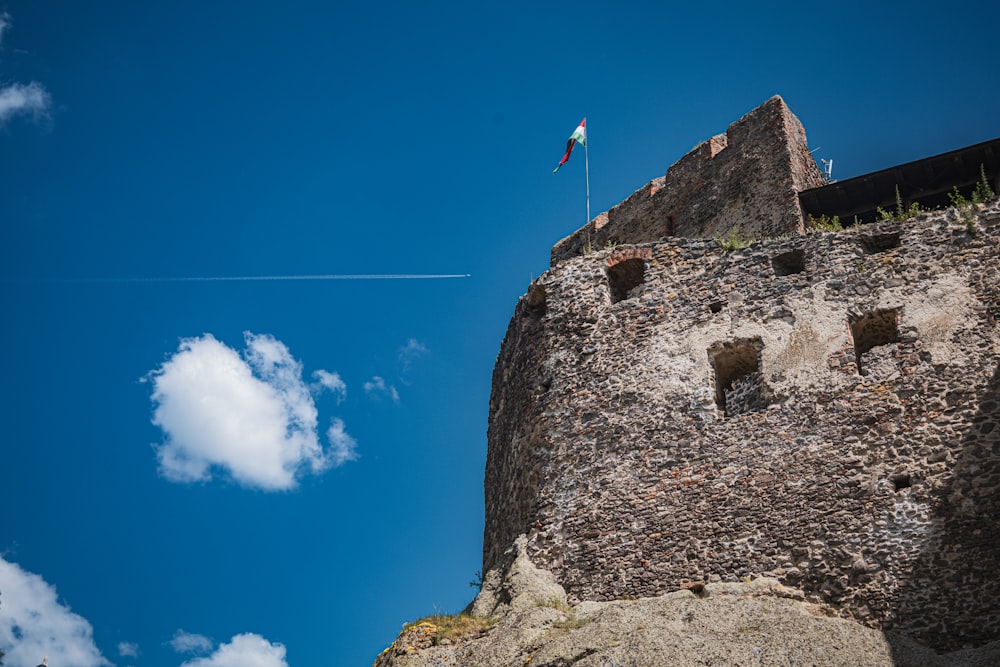 a kite flying in the sky over a castle