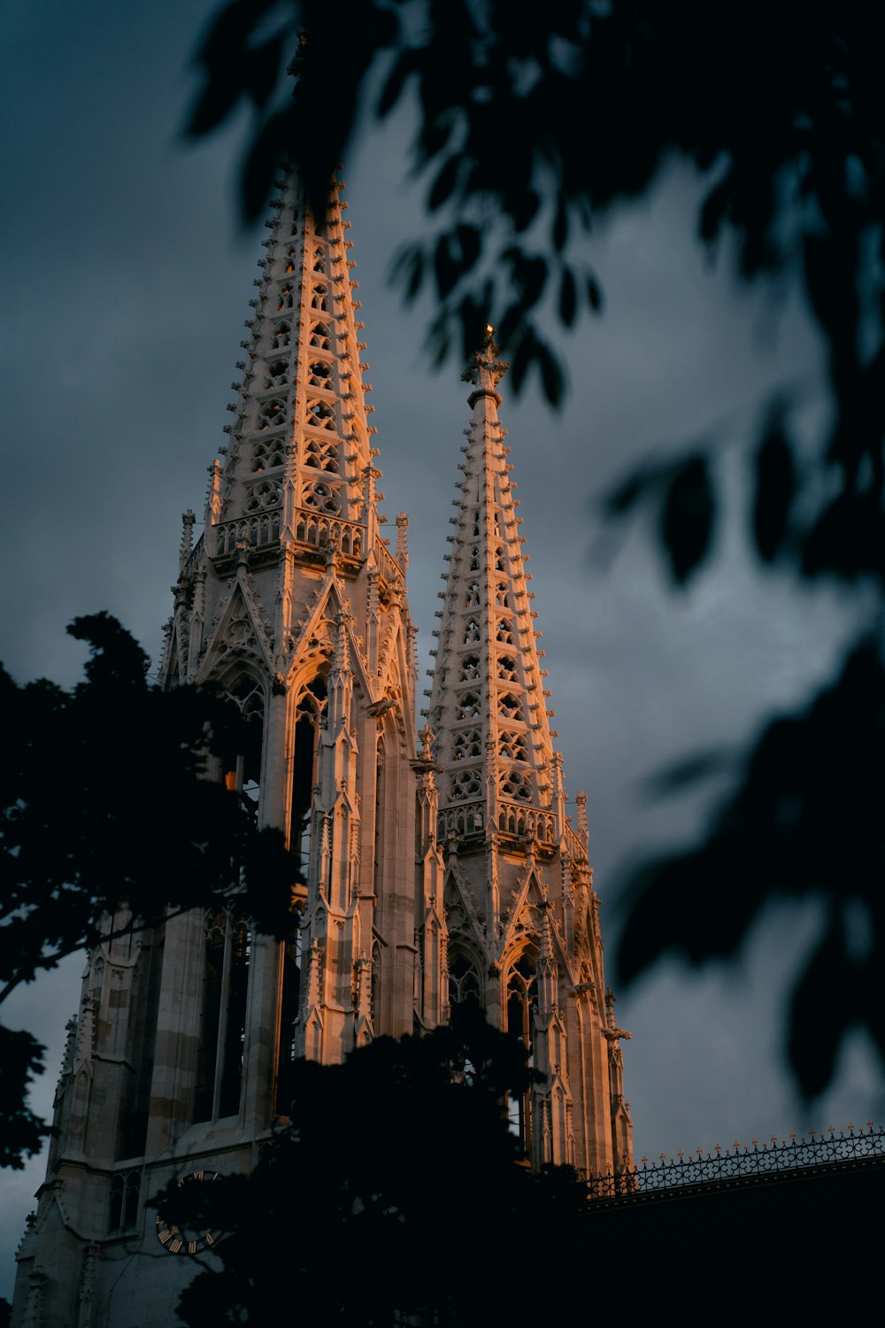 a large cathedral with many spires lit up at night