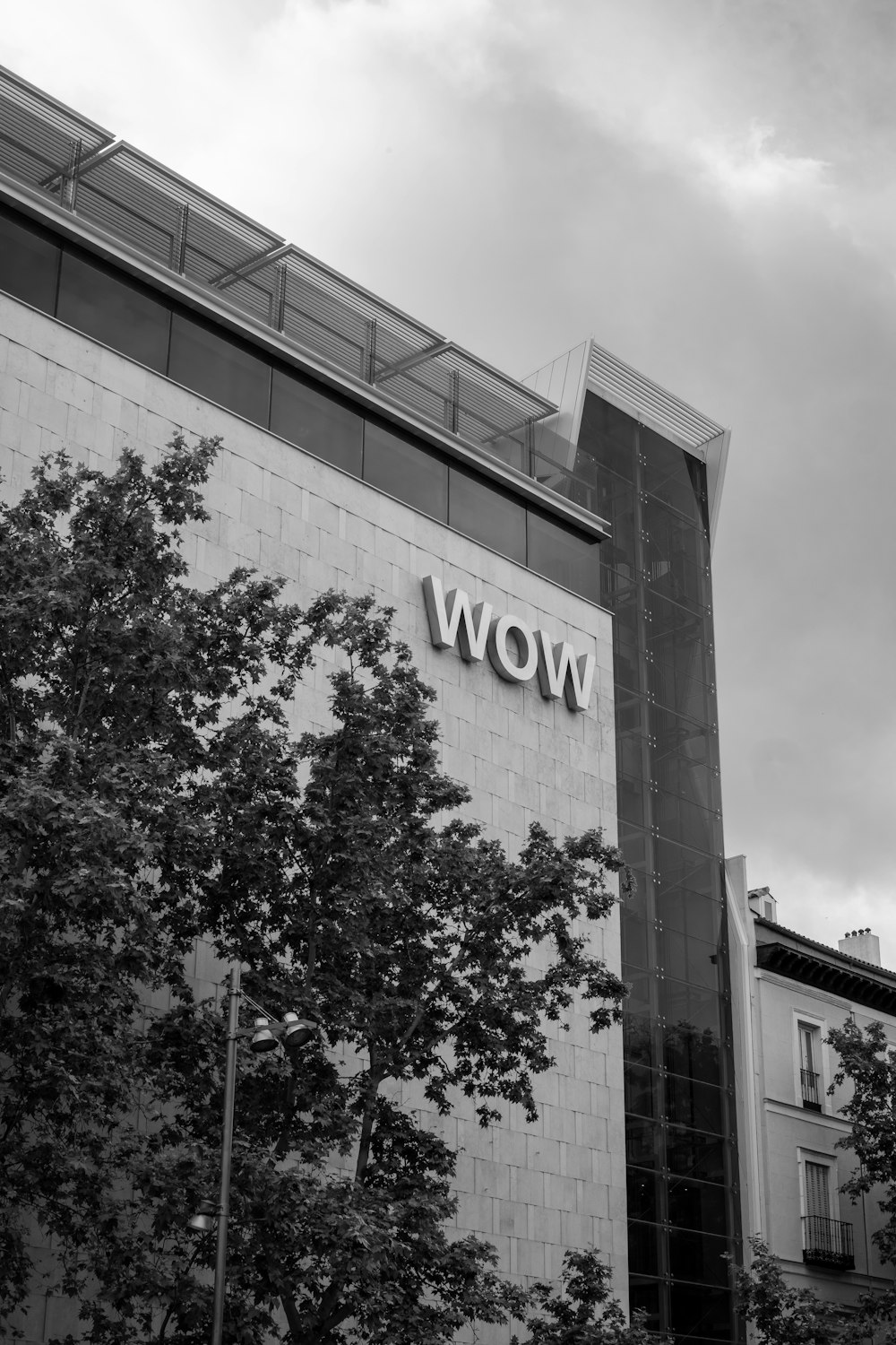 a black and white photo of a building with the word wow on it