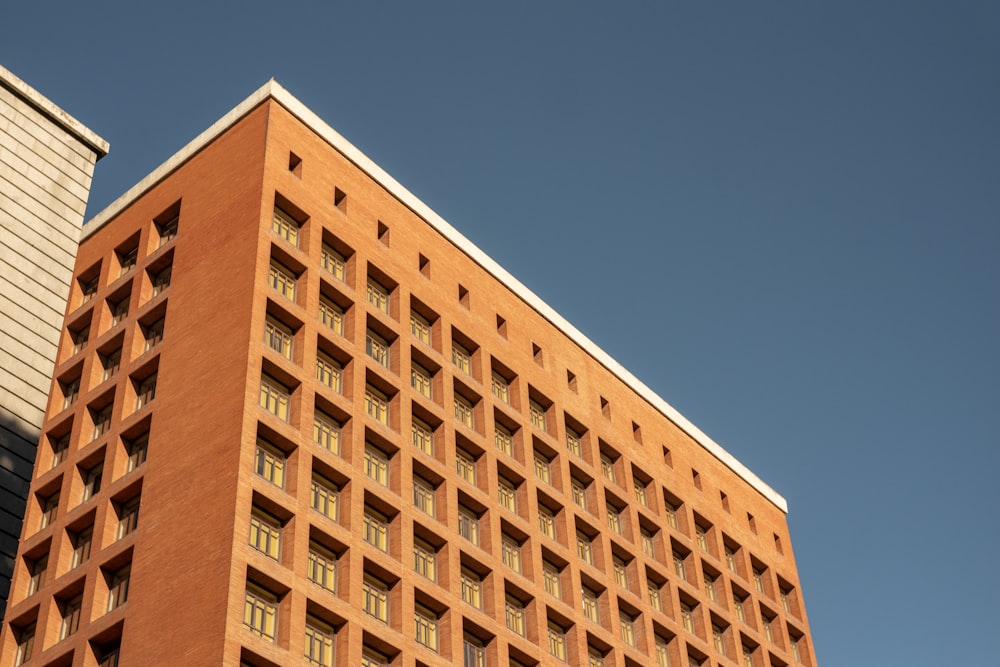 a tall brick building with a sky background