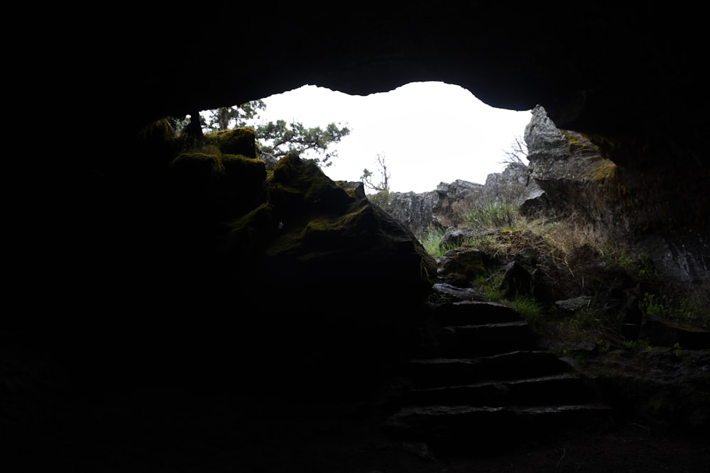 a dark cave with stairs leading into it