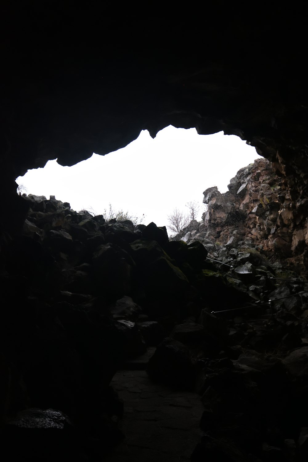 a cave entrance with a sky background